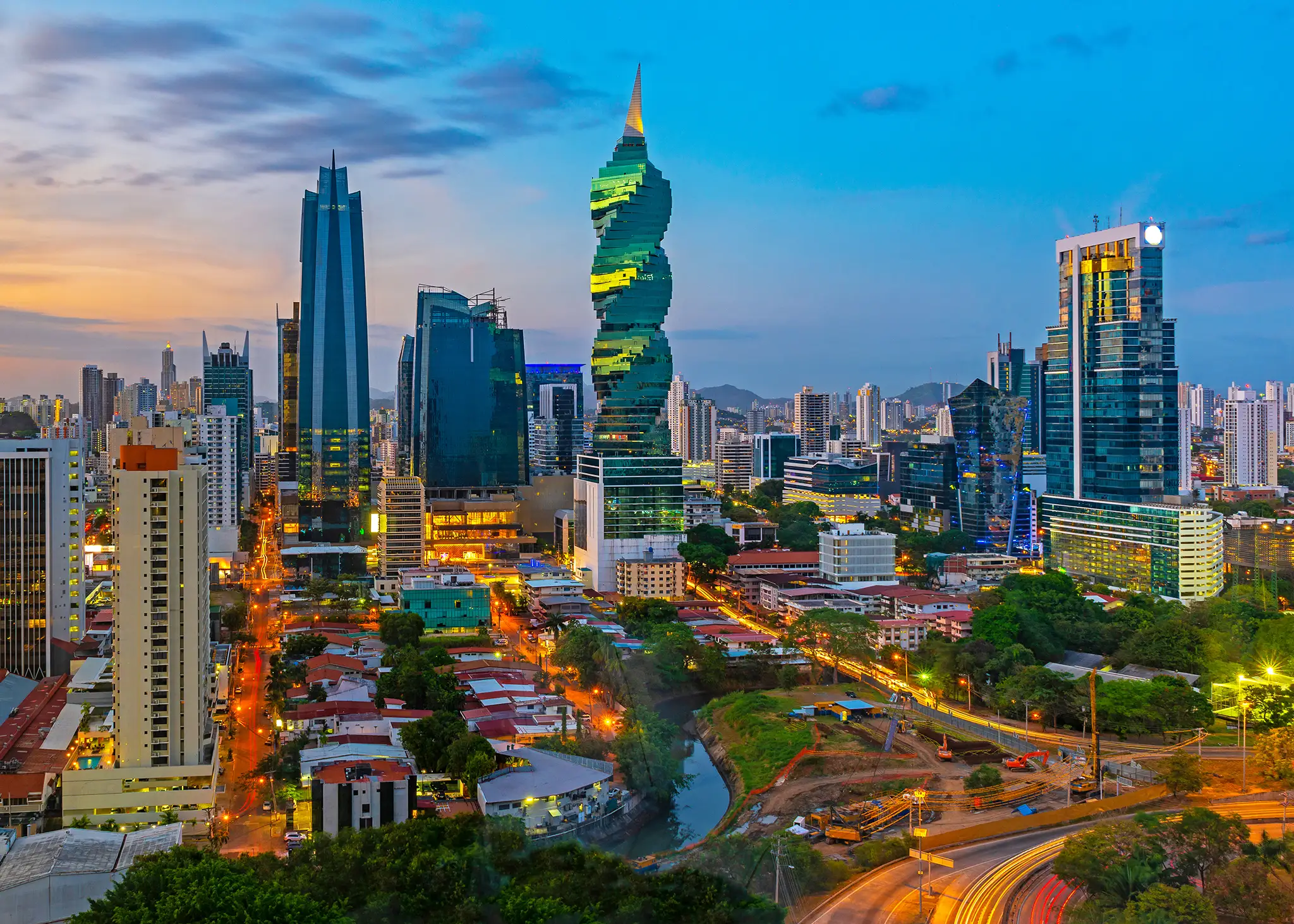 Colourful panoramic skyline of Panama City at sunset with high rise skyscrapers.