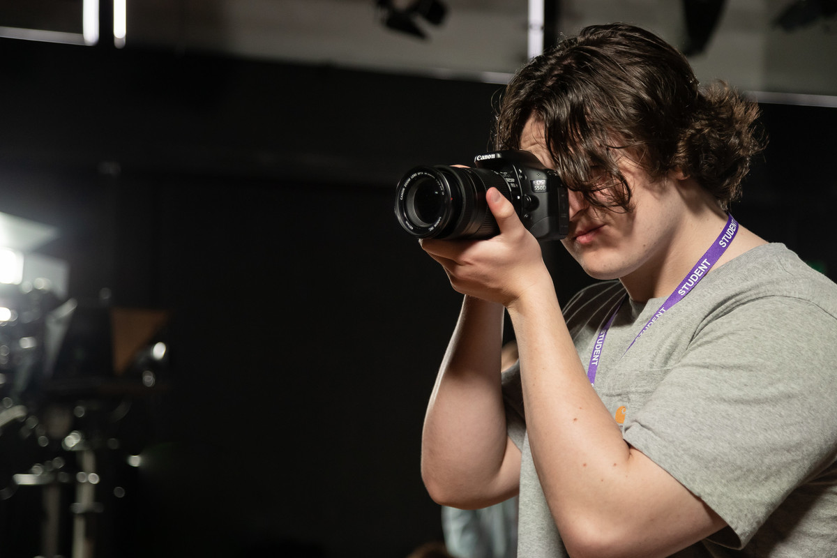 student taking a picture with camera
