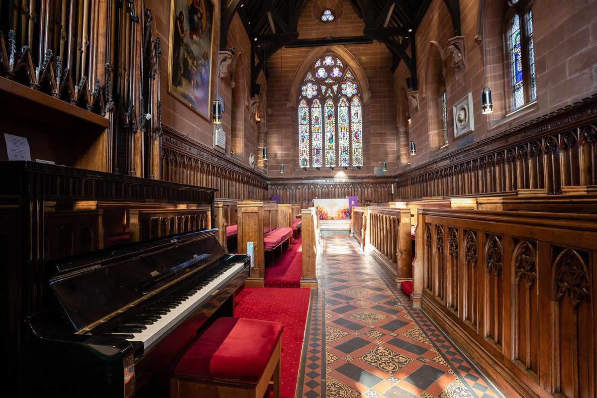 inside of chapel with pews and stained glass